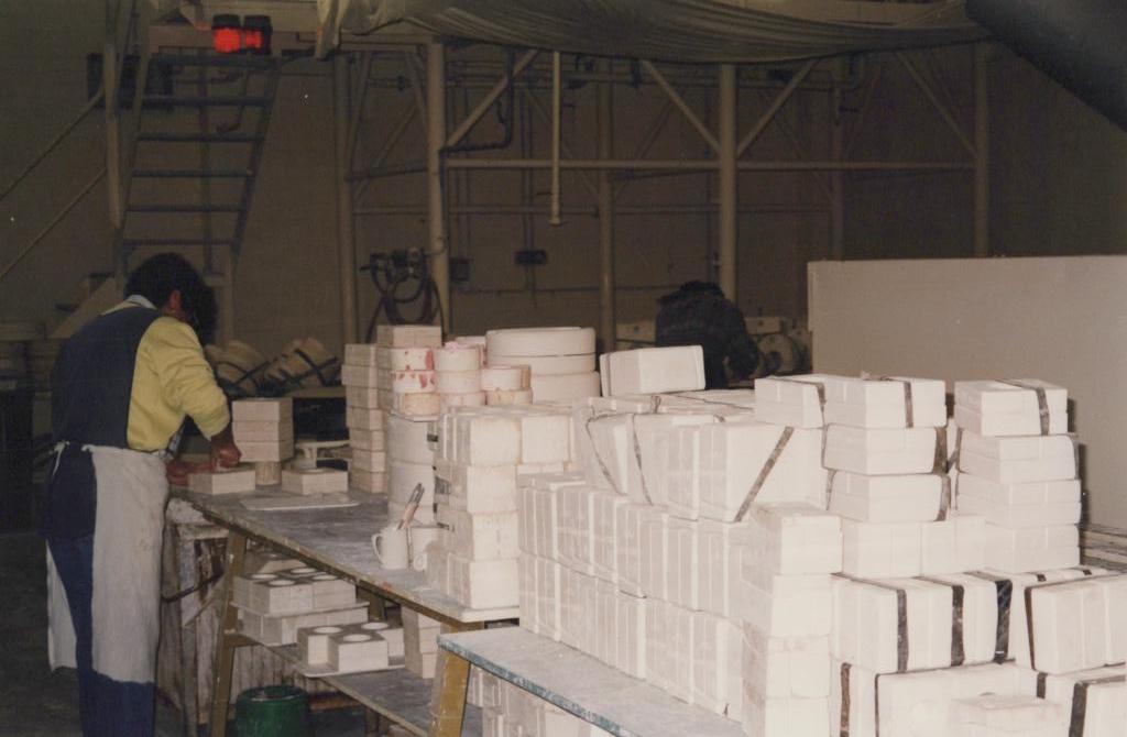 photograph of people working inside factory