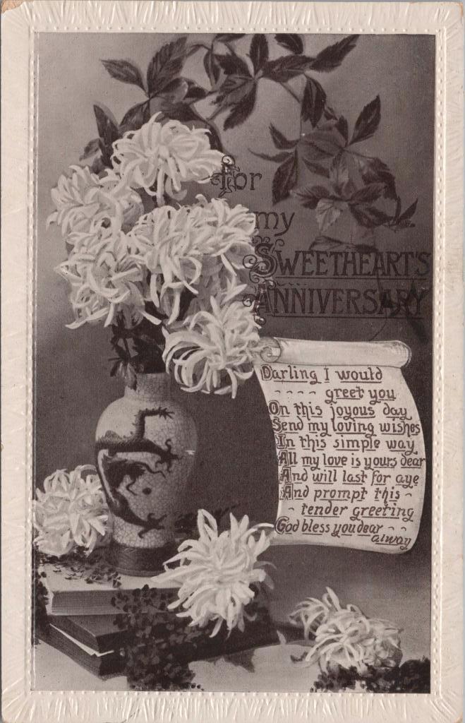 Postcard. Front: 'For my Sweetheart's Anniversary' with image of black and white vase and flowers on pile of books. There is a poem on the right.