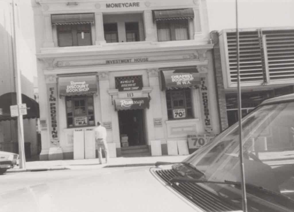 black and white photo of a car and building