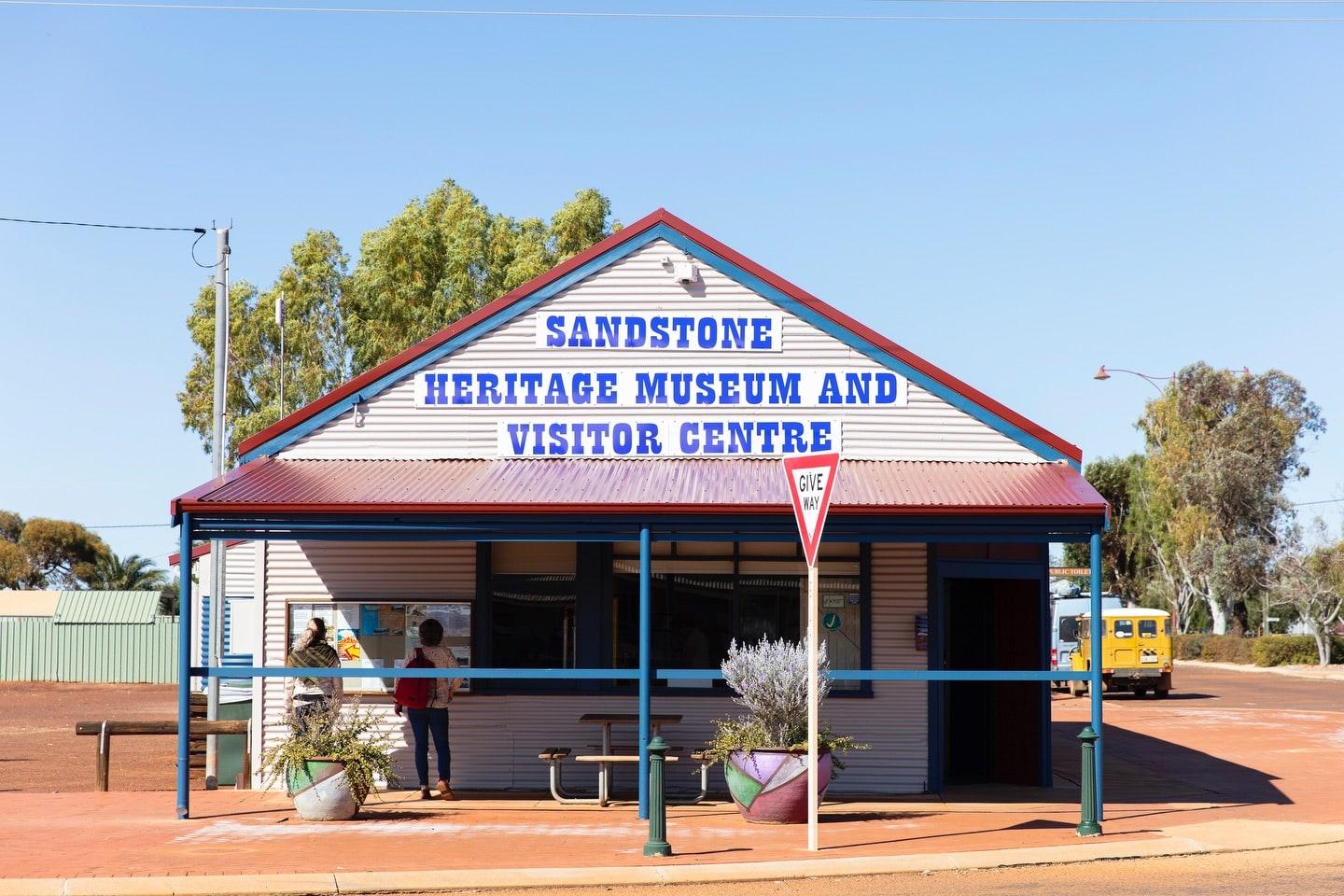 small building with a sign 'SANDSTONE HERITAGE MUSEUM AND VISITOR CENTRE' on its front