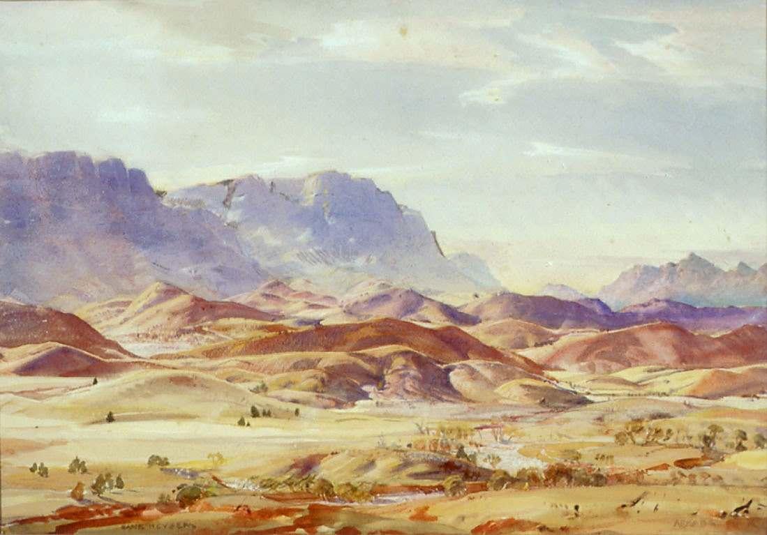 View of Flinders Range with reddish brown hills and pale green trees 