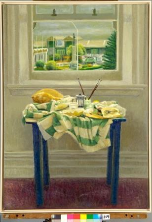 Oil painting depicting a small blue table featuring a green and cream tablecloth and various items in front of a window. There is a view of green buildings and vegetation from the window