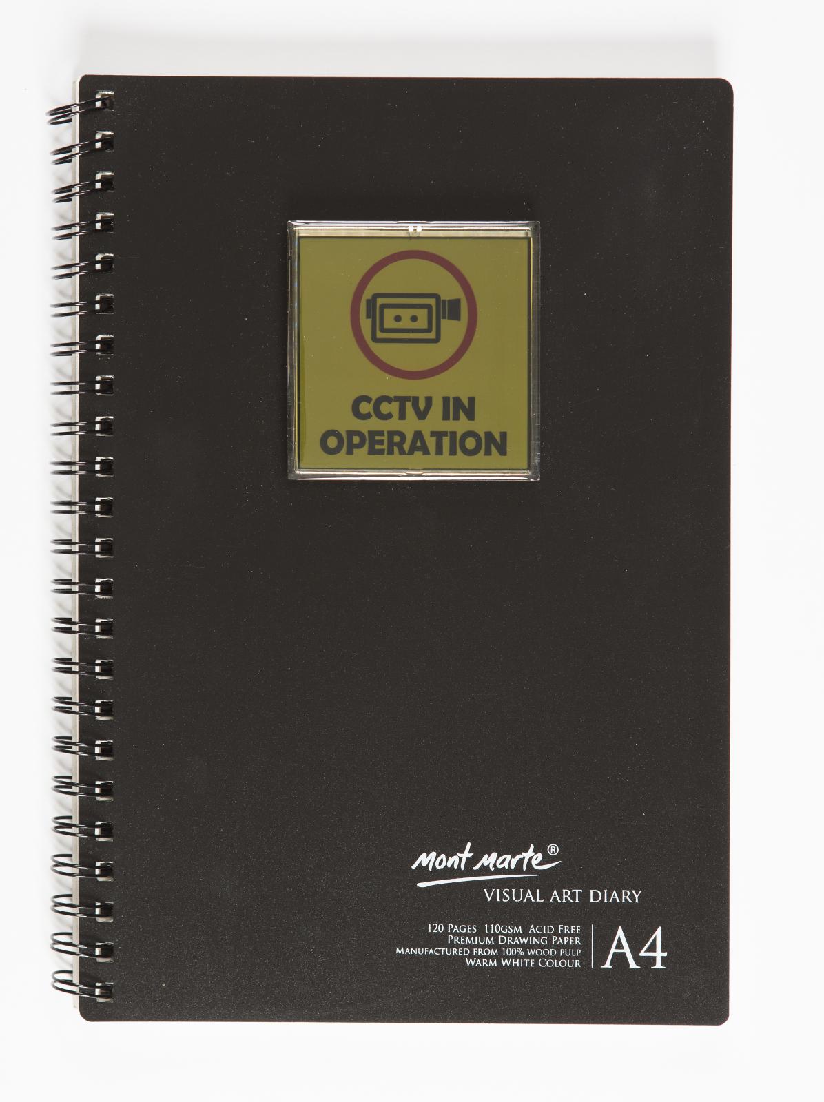 Black spiral bound A4 visual arts diary with plastic, yellow CCTV sign attached to the upper centre of the cover. The sign has black text "CCTV in operation" with an image of a recording camera circled in red above the text