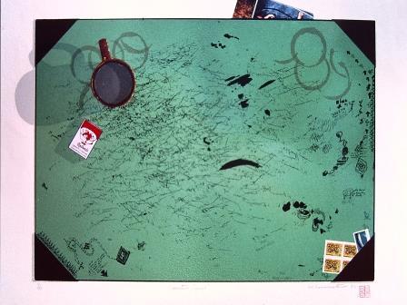 Top down view of the surface of a green table covered in graffiti 