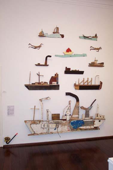 Image of 12 wooden boat and swimmer sculptures installed at Fremantle Arts Centre