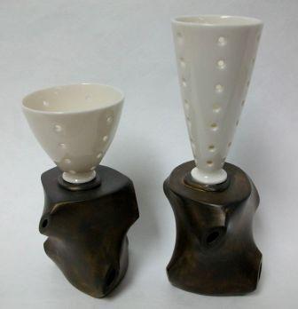 Image of two vase-like ceramic sculptures with black base and white top vessels