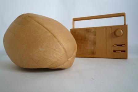 Deflated brown Australian football and brown radio