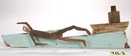 Sculpture depicting boat, waves and swimmer