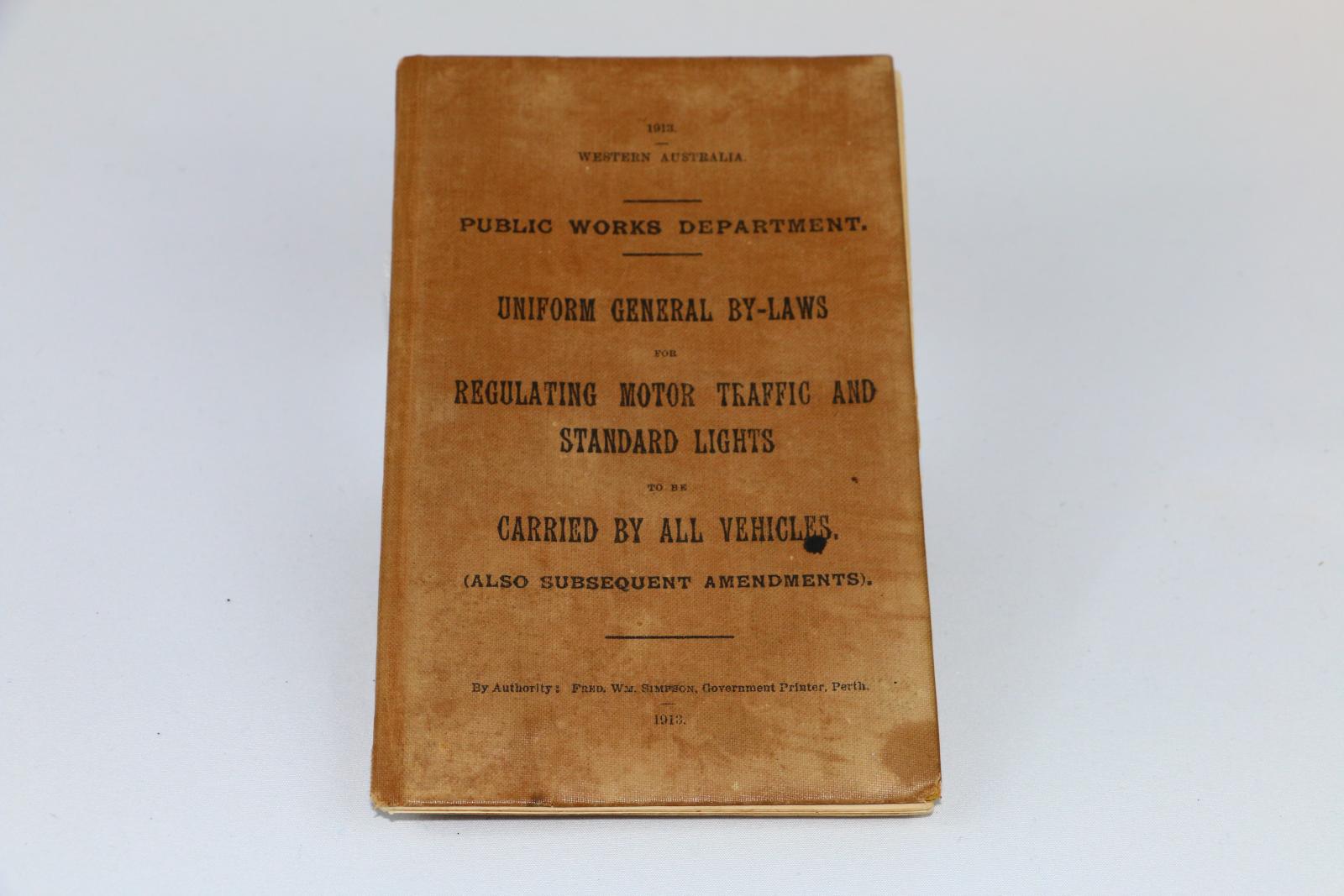 Tan hard covered book 'Public Works Department' 'Uniform General by-Laws Regulating Motor Traffic and Standard Lights to be Carried by all Vehicles'. 