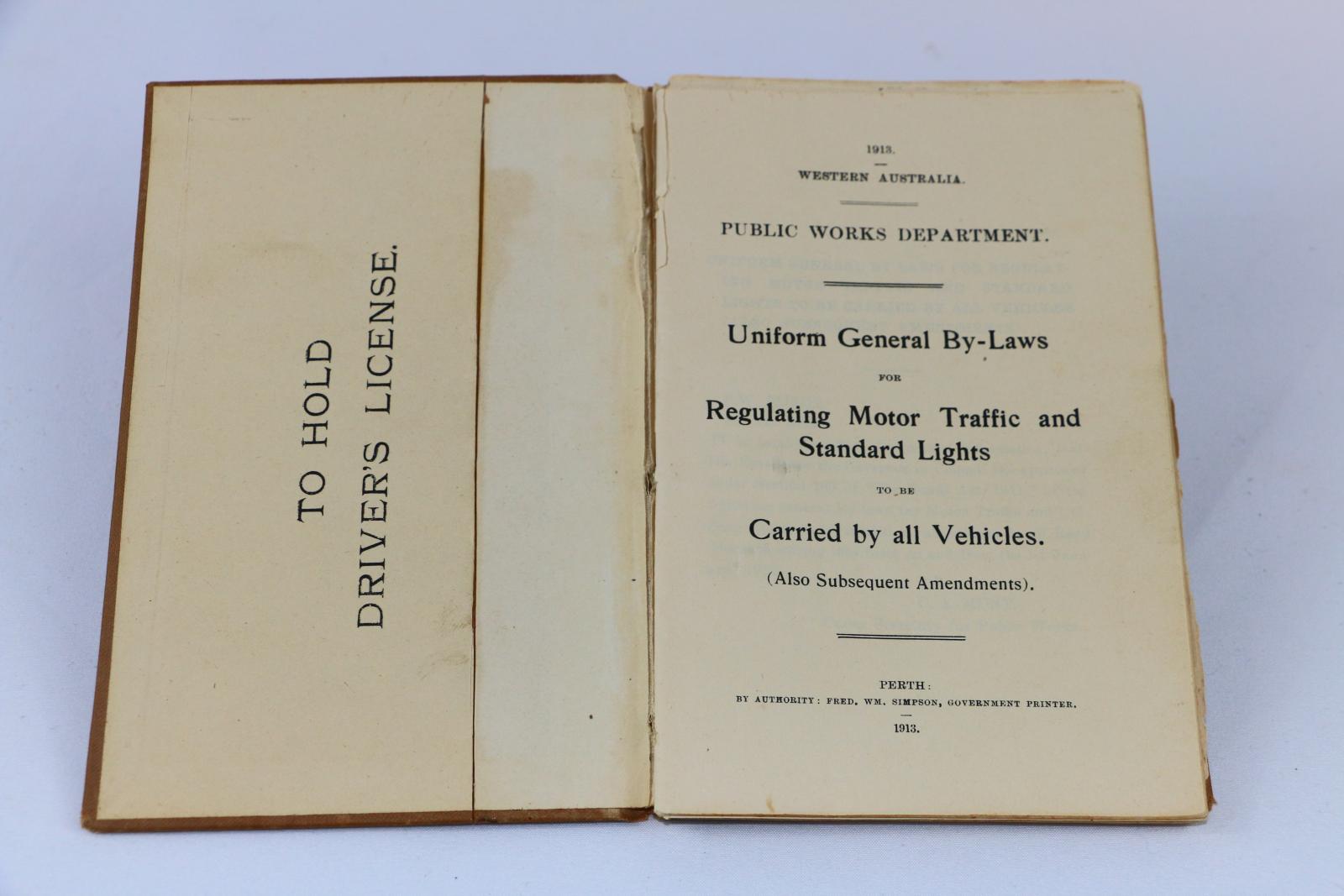 The inside cover of the book which shows a space for a drivers license and the title page.