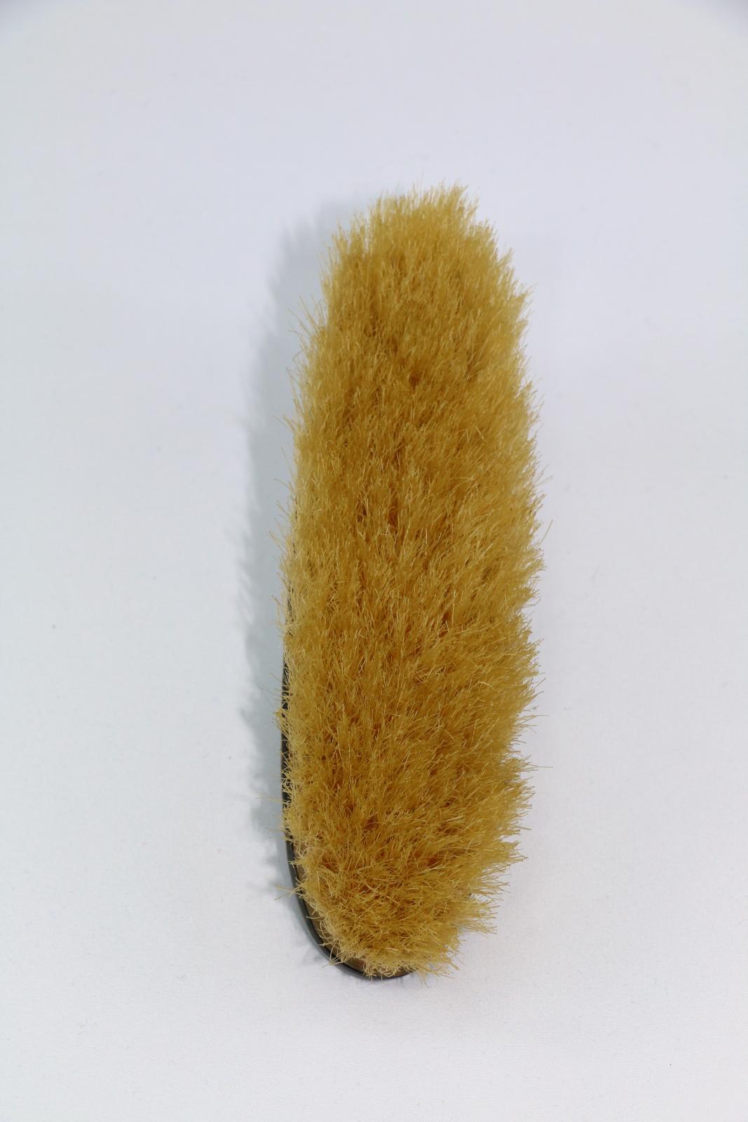 The front of a silver clothes brush.