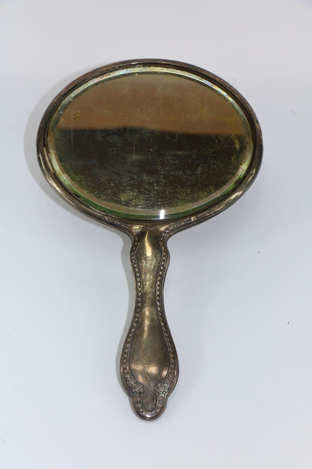 The front of a silver mirror.