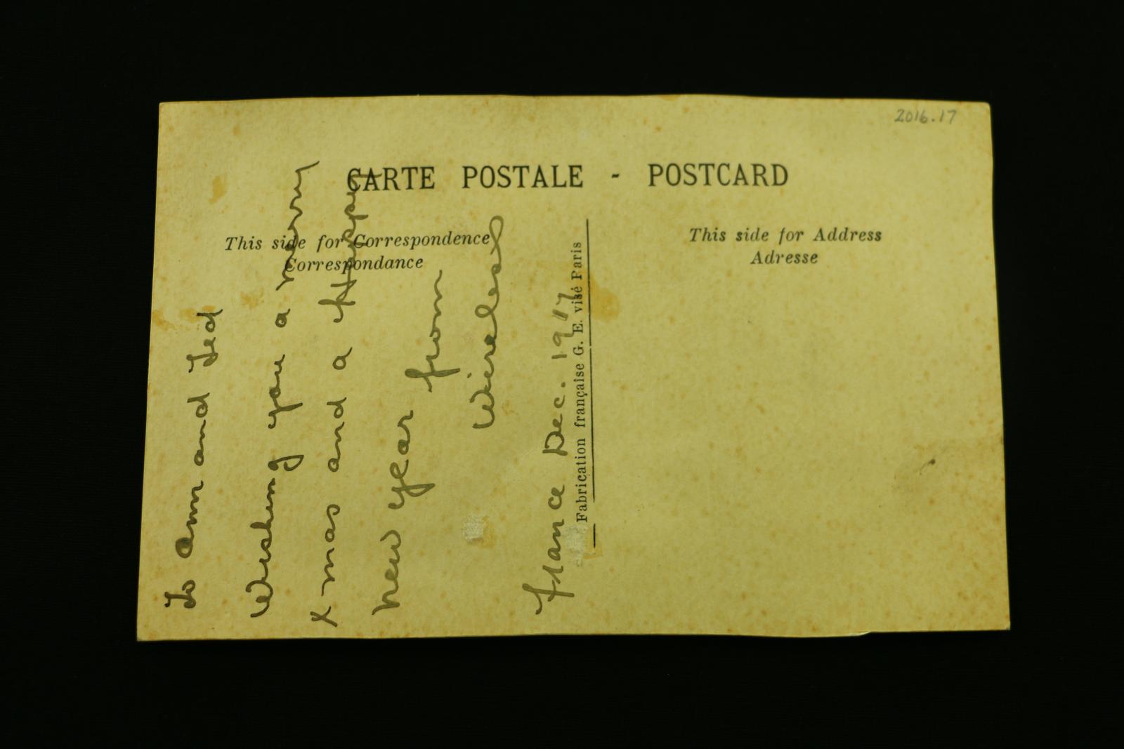 The reverse of the postcard which has a handwritten Christmas message.