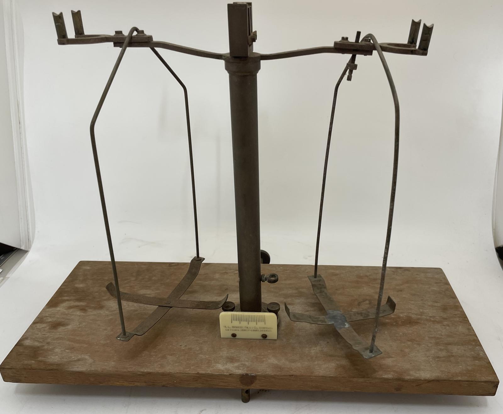 Brass analytic balance scales on wooden base