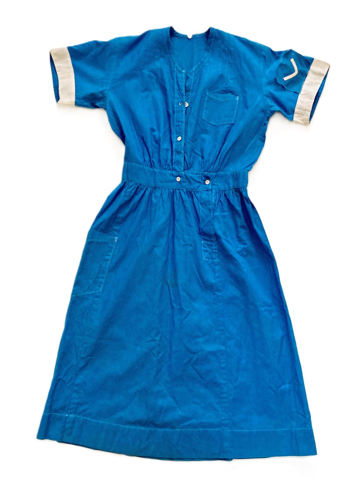 Blue and white nurse's uniform belonging to Betty Kelly with one chevron on sleeve indicating first year training