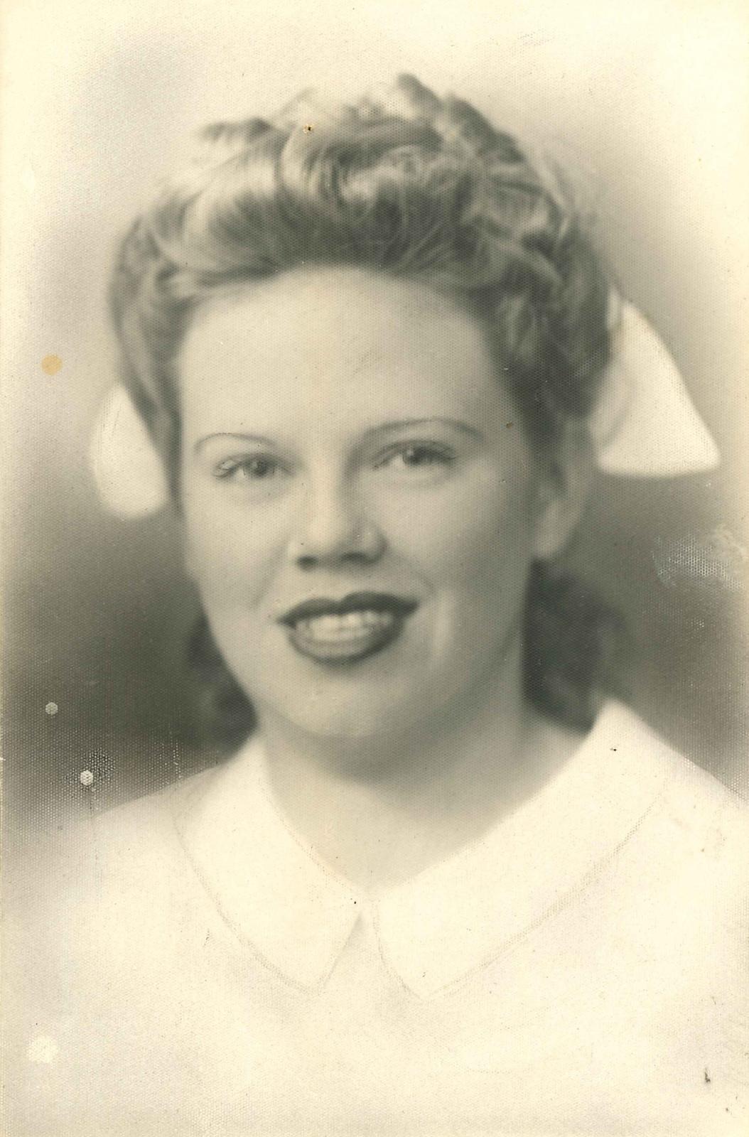 Black and white unframed portrait of Betty Kelly in nurse’s cap and uniform.