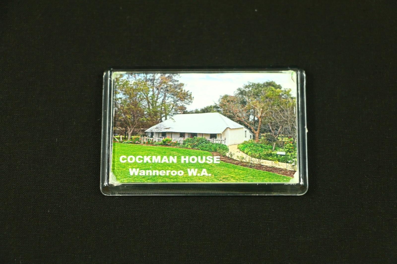 Rectangular, landscape orientation, plastic magnet featuring a photograph of Cockman House and white text reading 'COCKMAN HOUSE / Wanneroo W.A.'. 