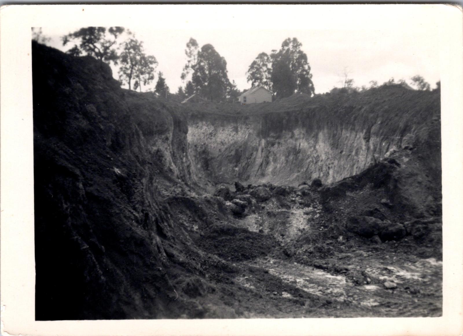 Police station building visible at top of open cut on Blackwood Road Greenbushes