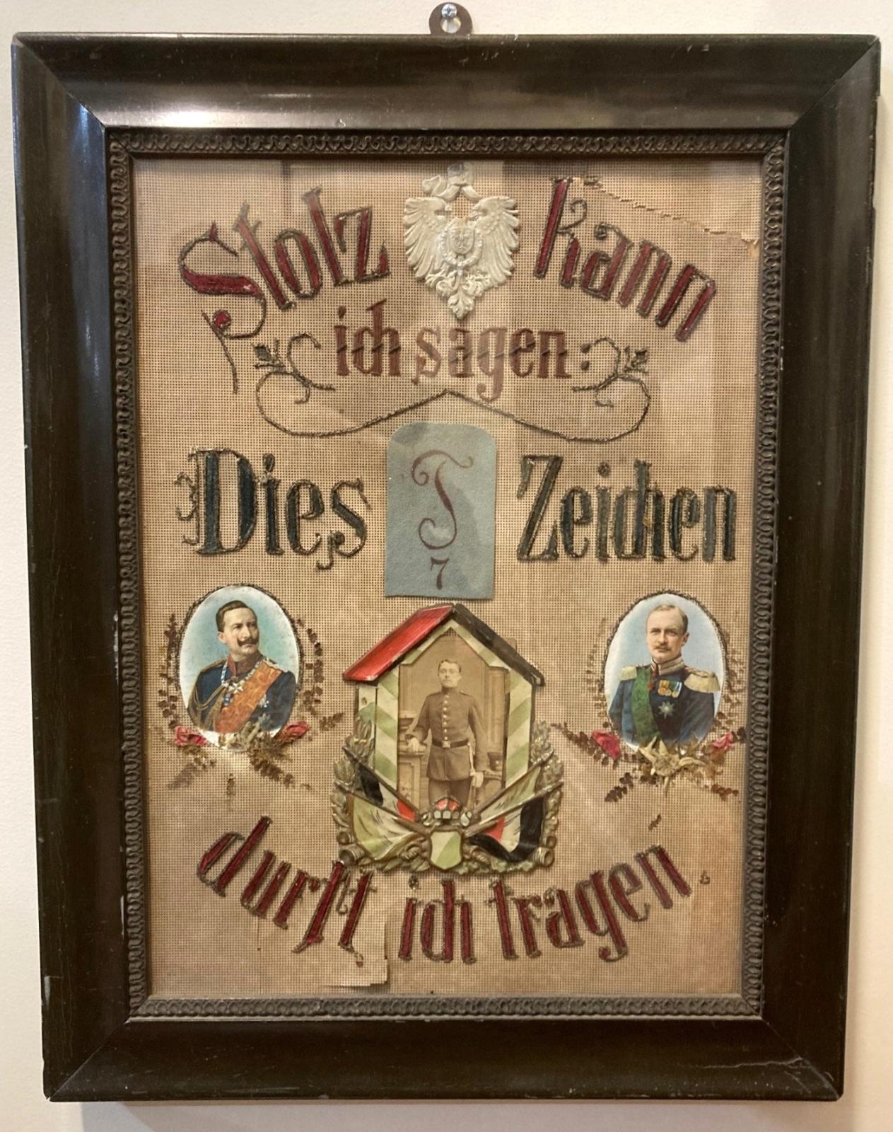 Framed decorative German WWI artwork containing portrait of soldier in centre