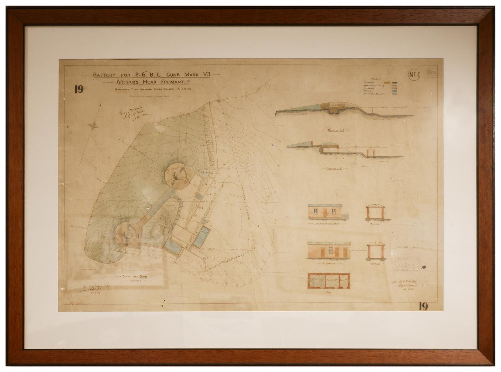 The image shows an architectural or engineering blueprint titled "Battery for 2.6' B.L. Guns Mark VII, Arthur's Head Fremantle." It depicts a detailed layout of a coastal defense battery with two circular gun emplacements and associated infrastructure at Arthur's Head, Fremantle. The plan is annotated with handwritten notes and features cross-sections of various structures, including a shelter, magazine, and other defensive facilities .The drawing includes elevation views of buildings and terrain, with colo