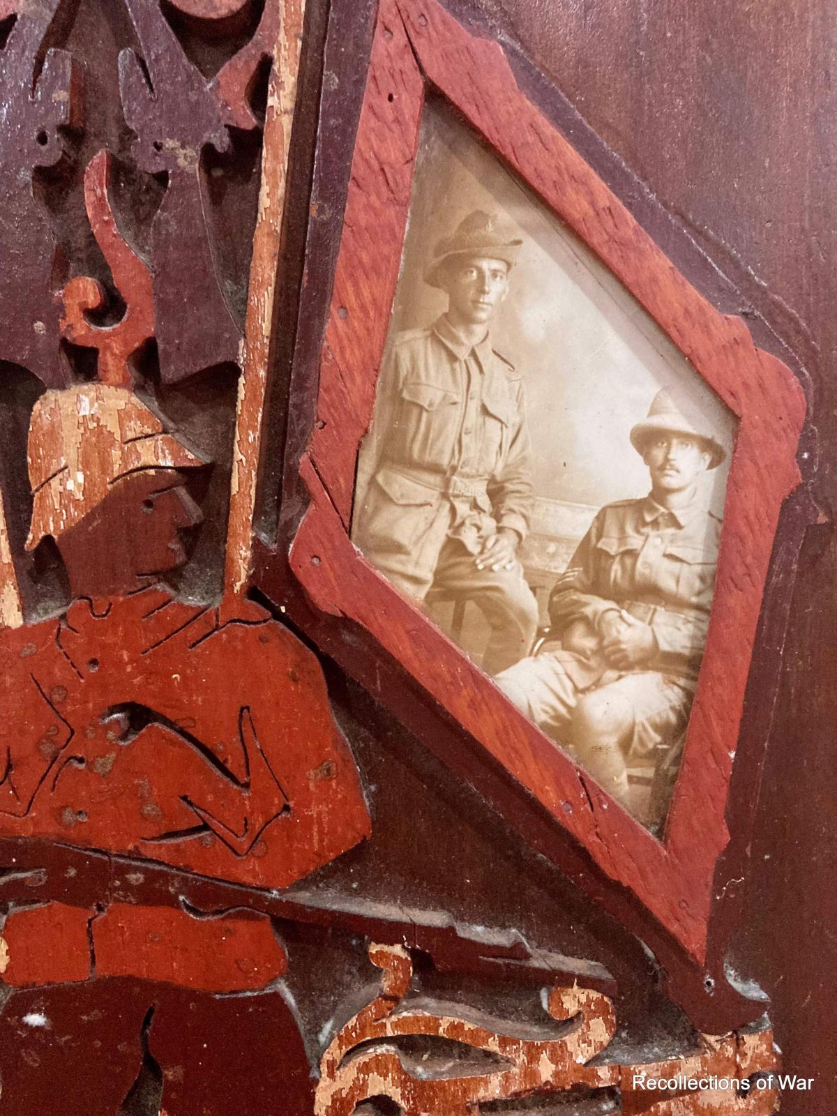 Portrait of two soldiers framed inside the outline of a timber flag