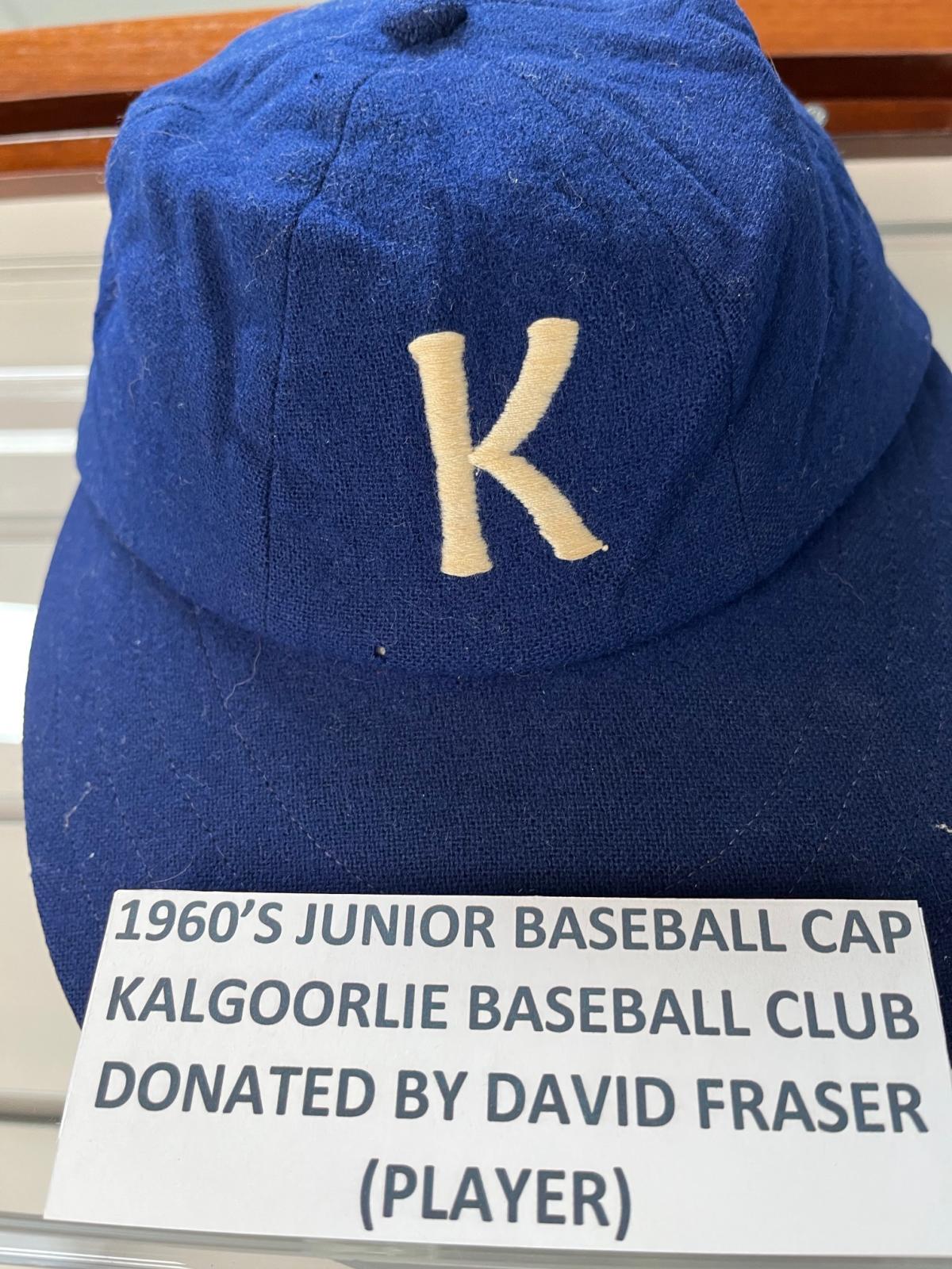 blue baseball cap with a white letter K on the front