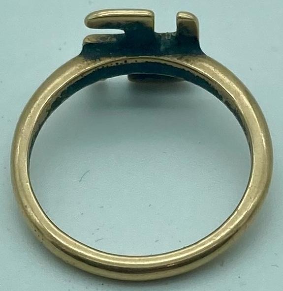 Reverse of WWI era gold ring featuring good luck symbol