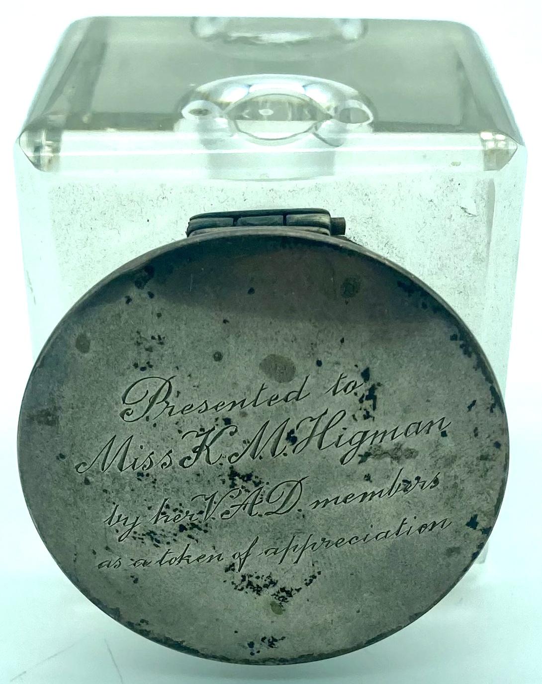 Top view of crystal glass inkwell showing inscription on silver lid