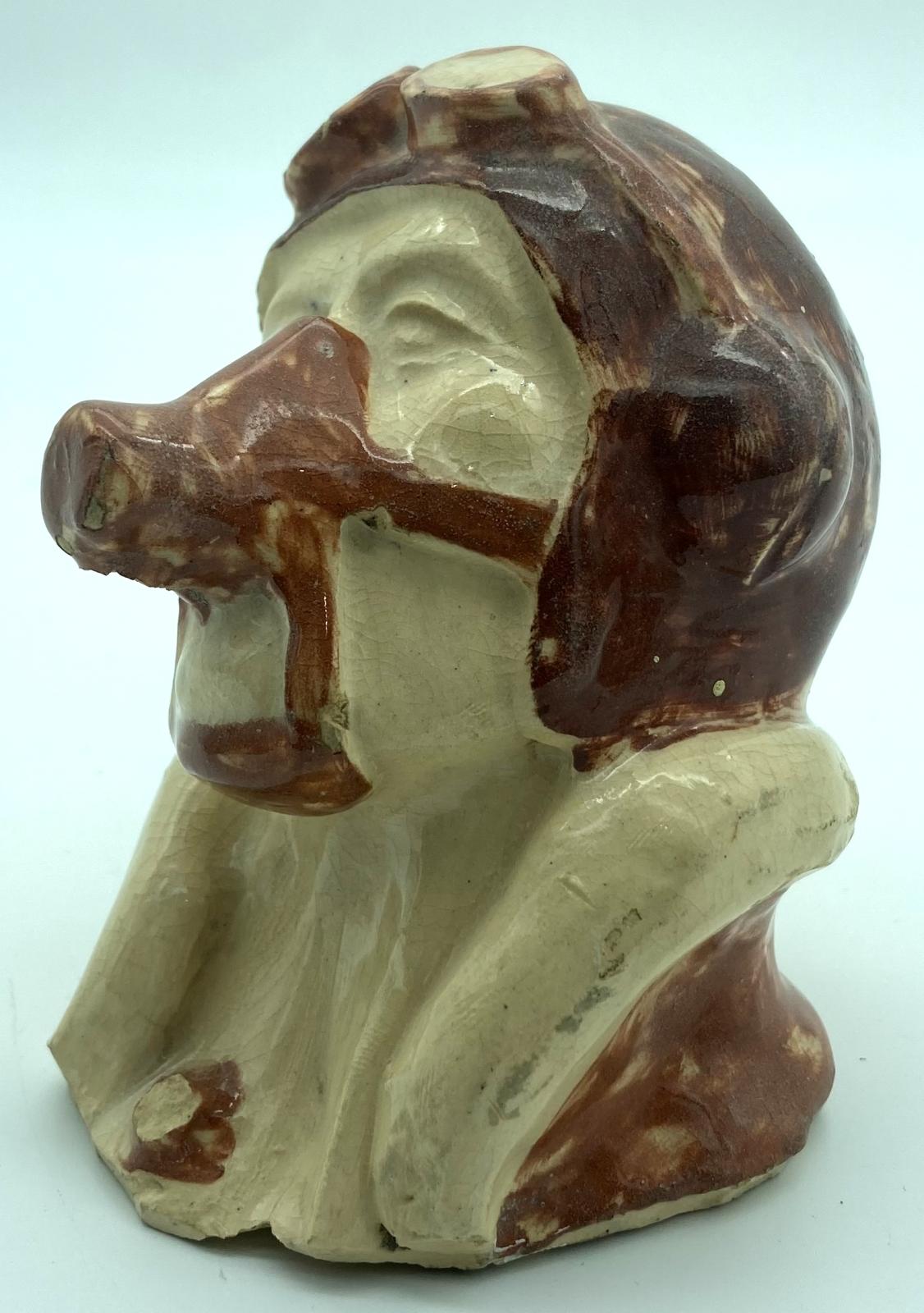 Side view of pottery bust of airman