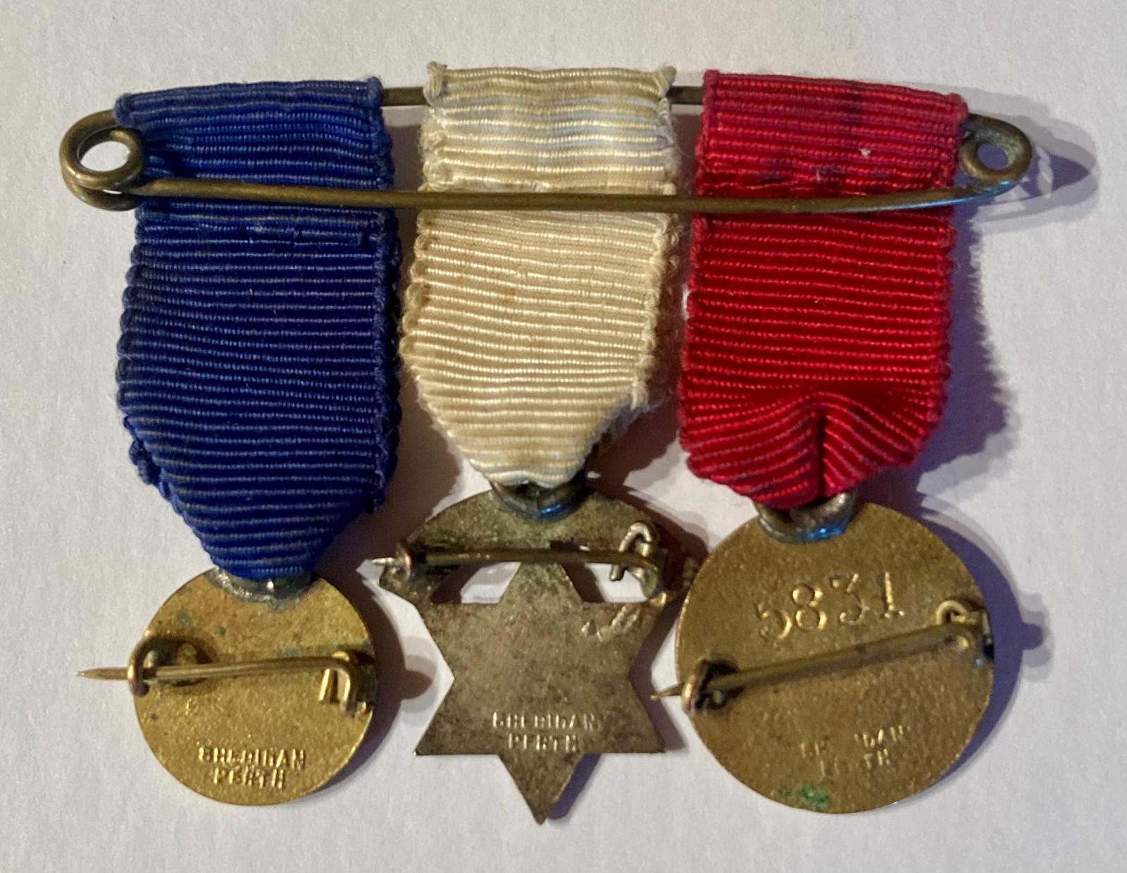 Group of three miniature charity medals reverse