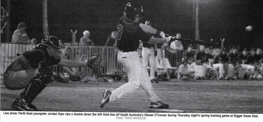 black and white photo of a baseball player hitting a baseball