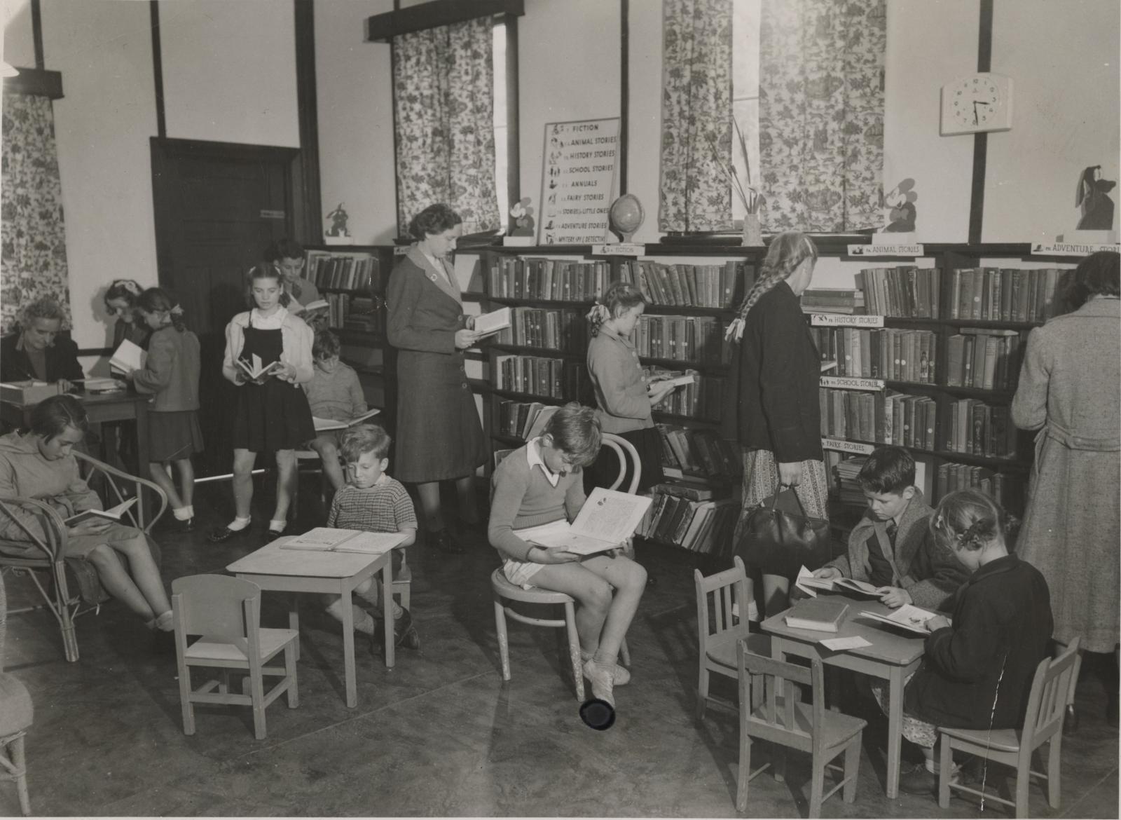 Children reading books in a public library