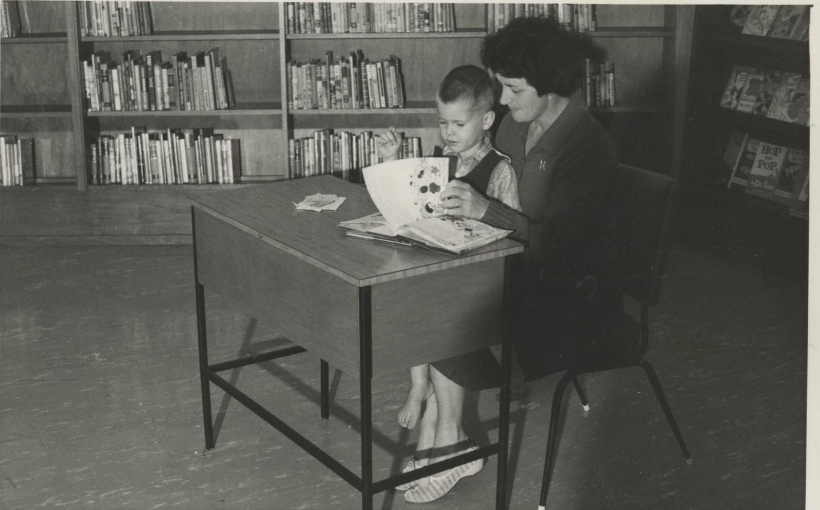 Woman and child in a library.