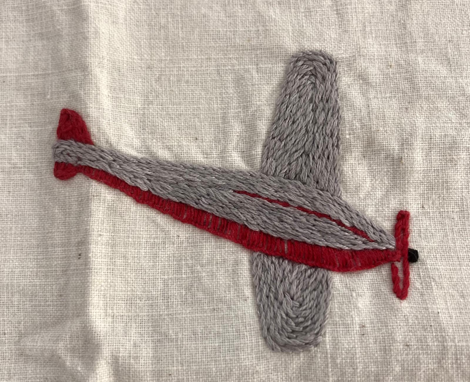 Hand-embroidered apron - Centenary Air Race - showing winning plane