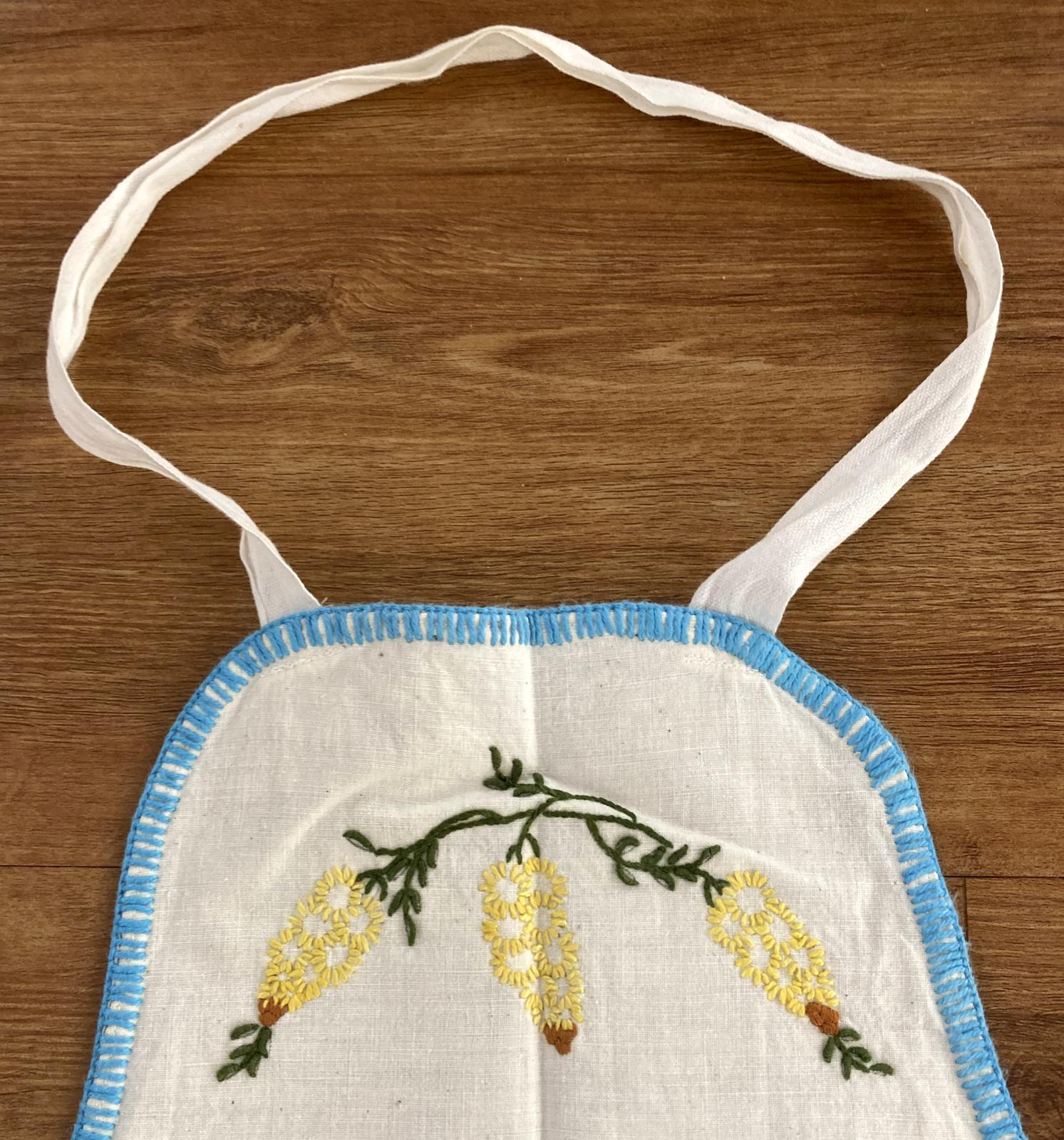 Hand-embroidered apron - Centenary Air Race - showing wattle