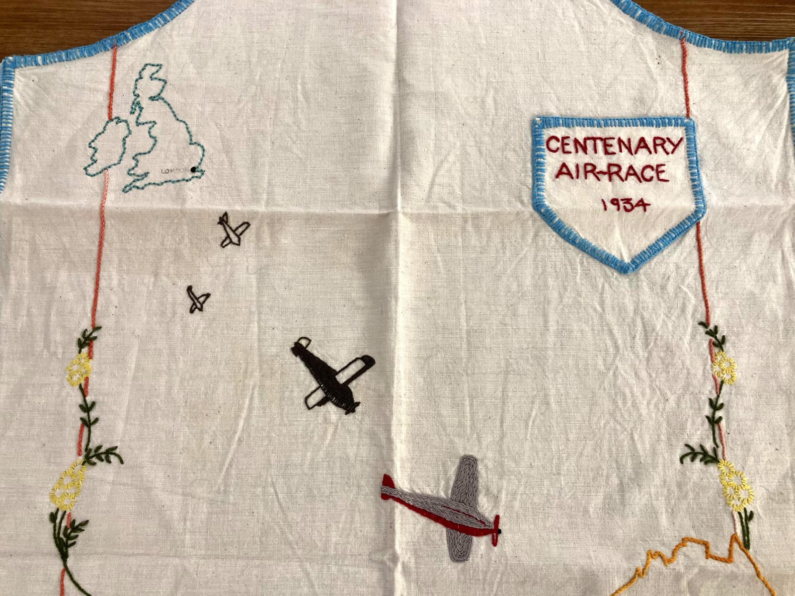 Hand-embroidered apron - Centenary Air Race - showing detail