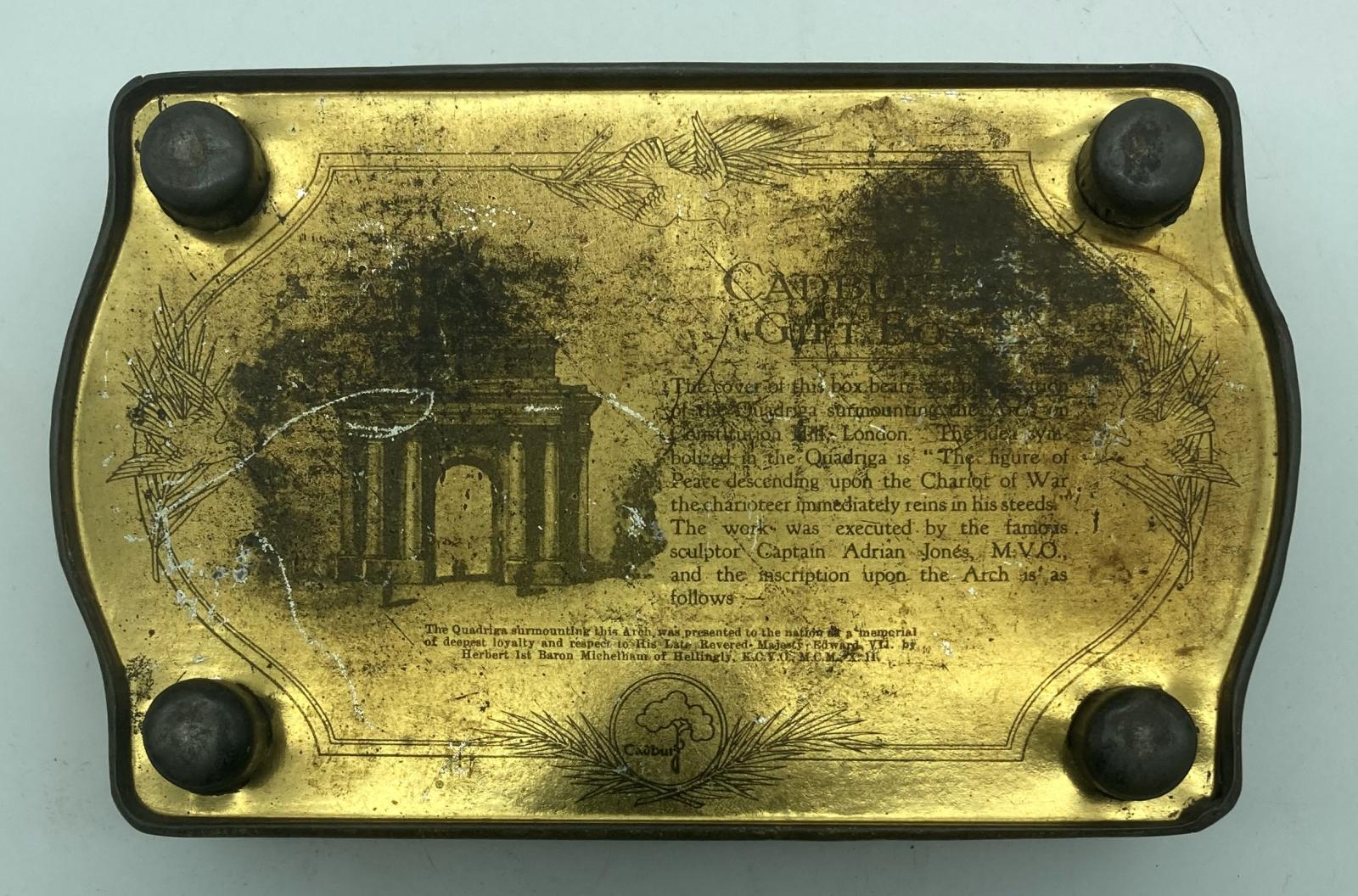 Bottom view of Cadbury tin showing feet and information