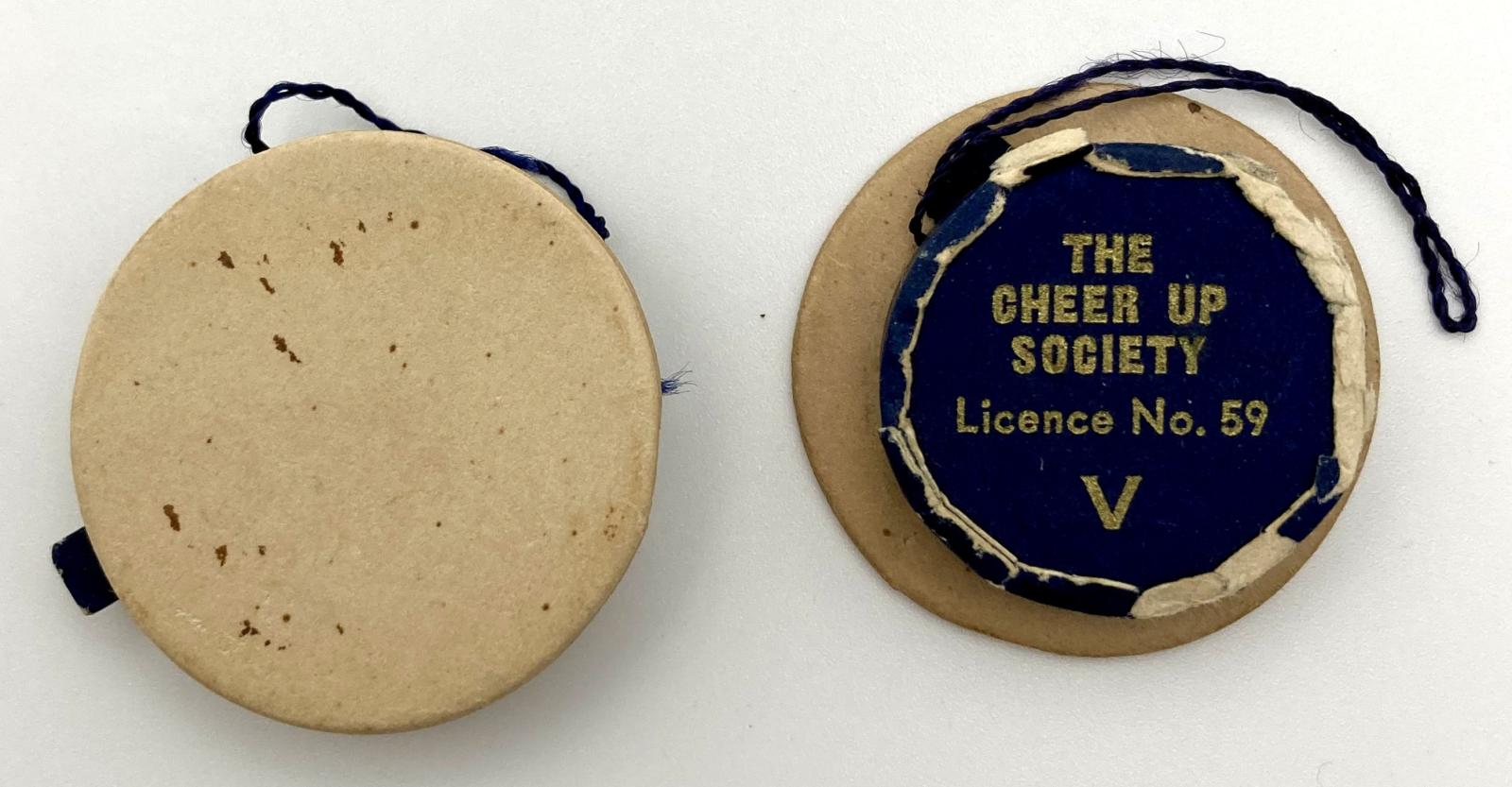 Top and bottom view of of Cheer-Up Society fundraising pins in shape of naval caps