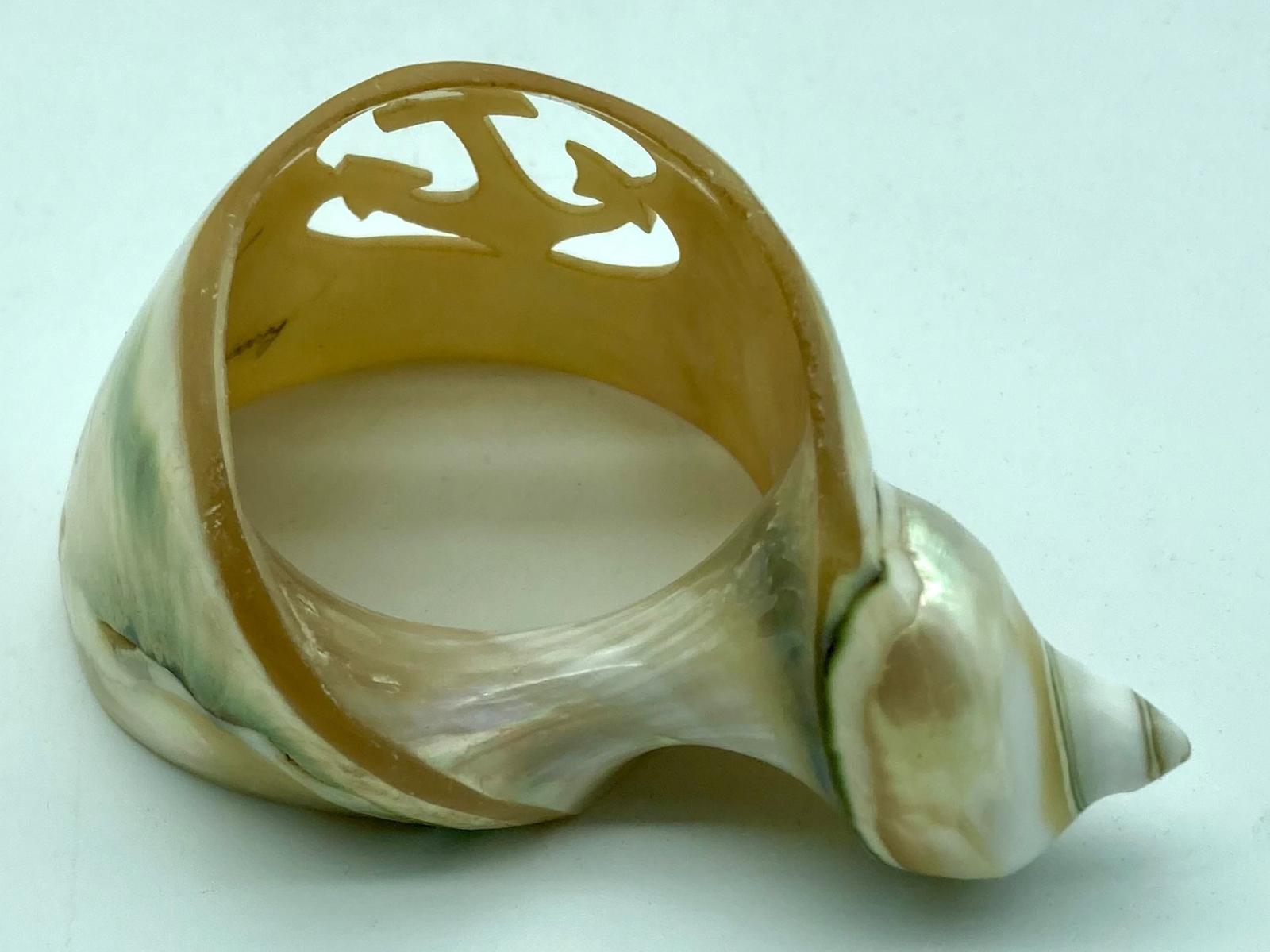 Back view of carved shell napkin ring 