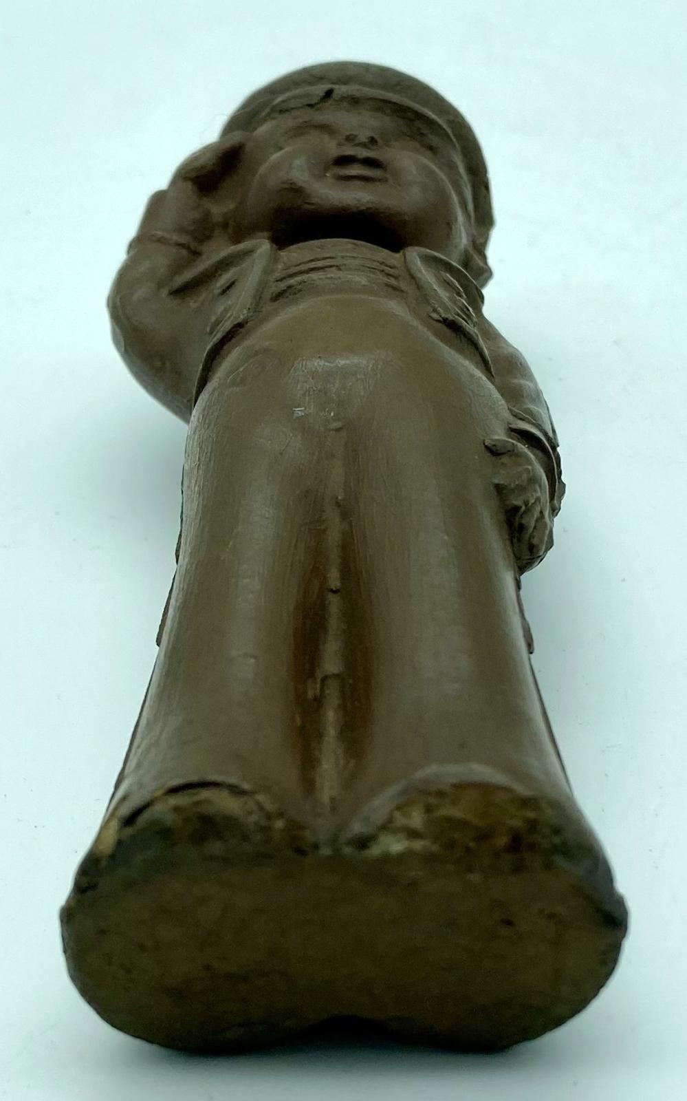 Bottom view of lacquered, brown rubber sailor doll