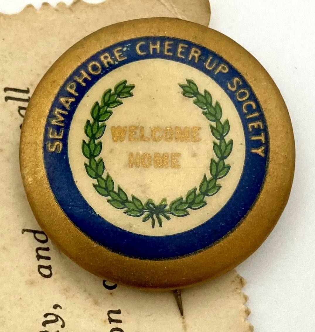 Close-up of badge - Semaphore Cheer-Up Society