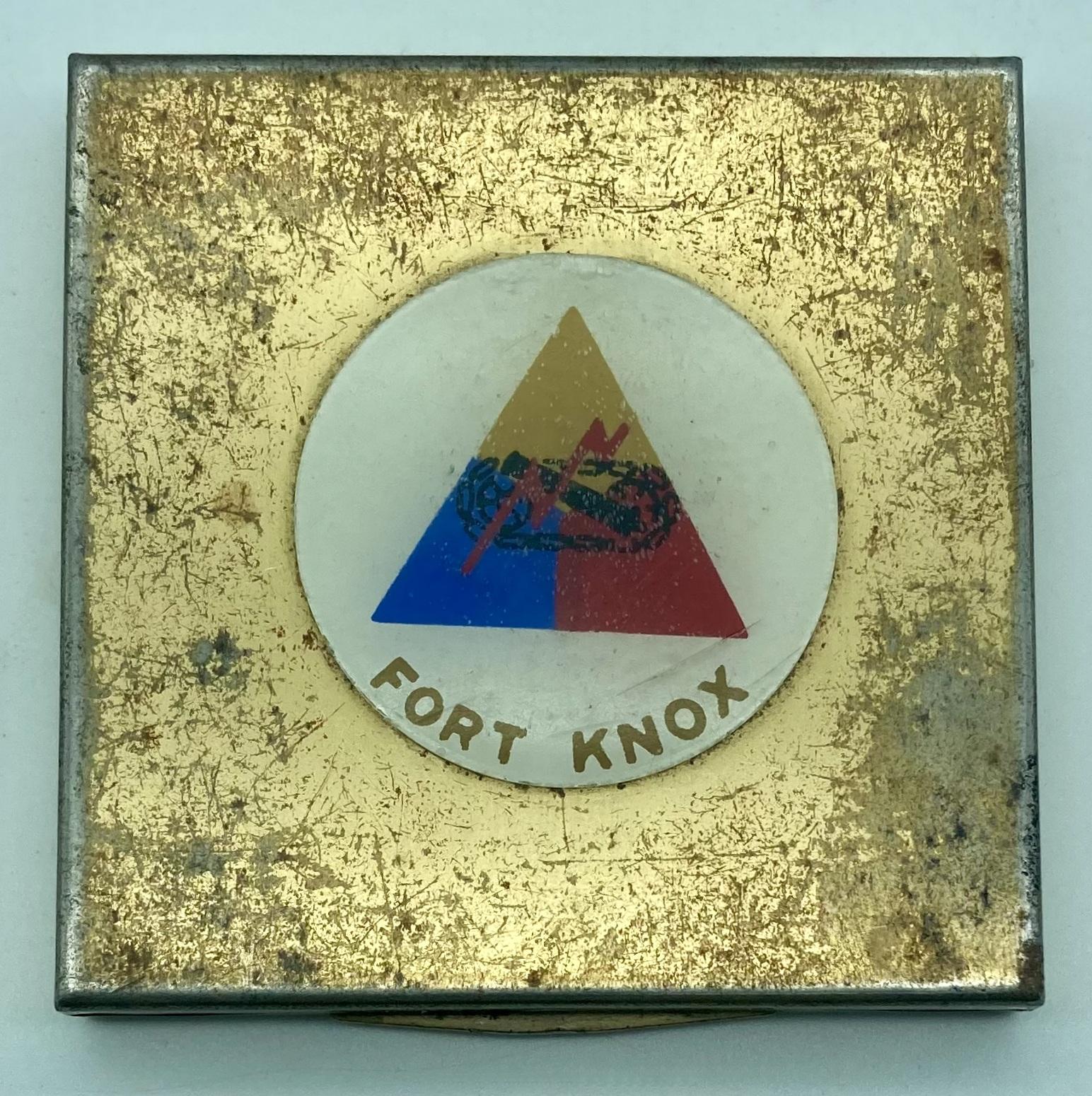 Gold-toned powder compact with Fort Knox logo