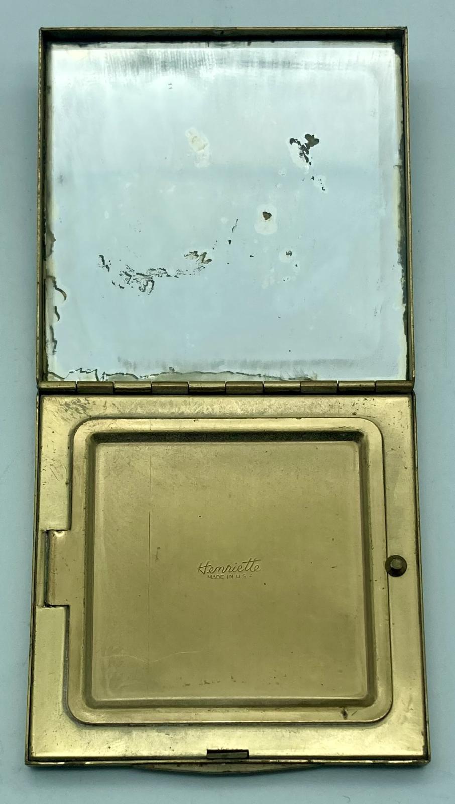 Gold-toned powder compact with Fort Knox logo showing mirror