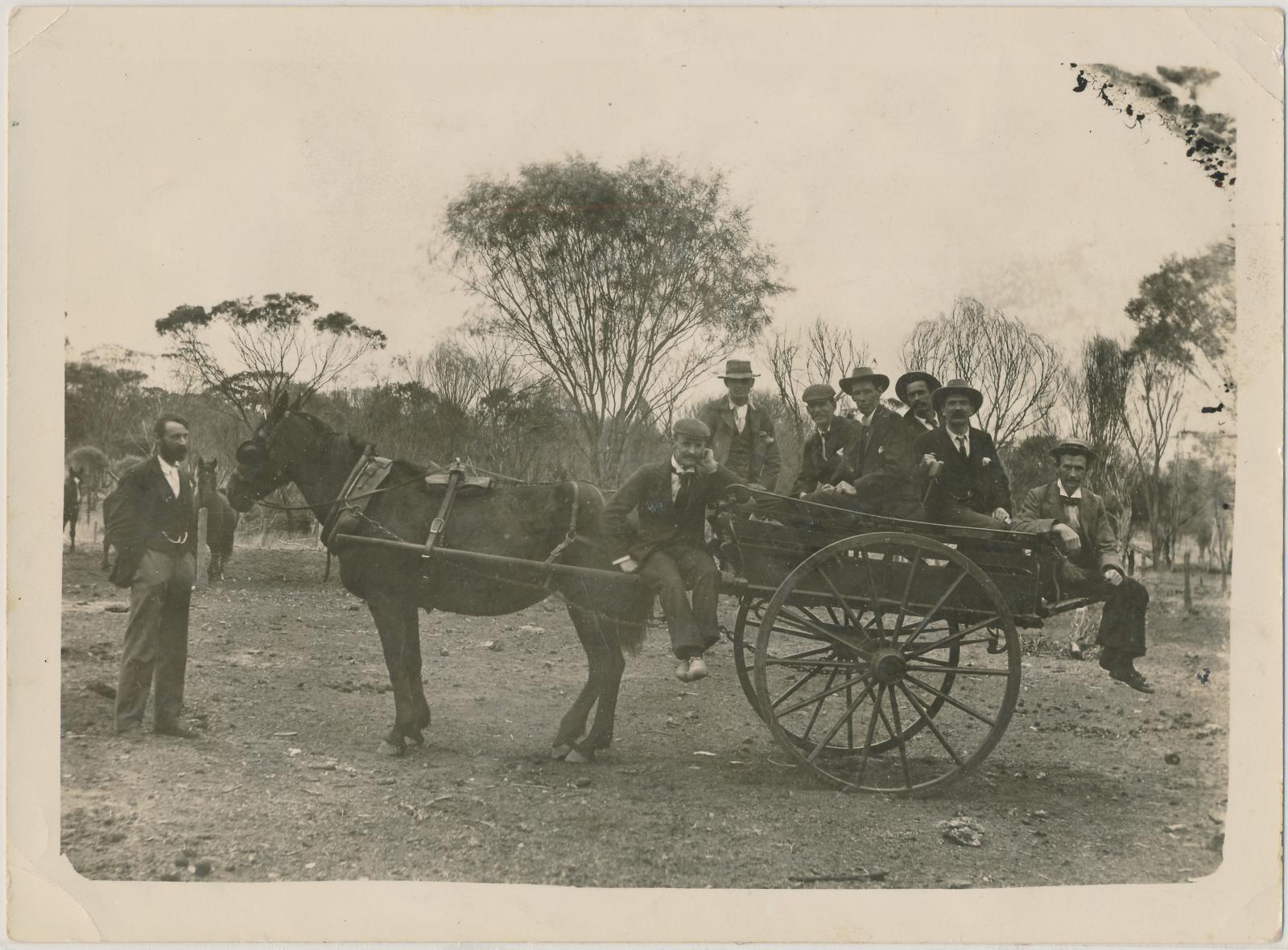 Men sitting in a Sulky