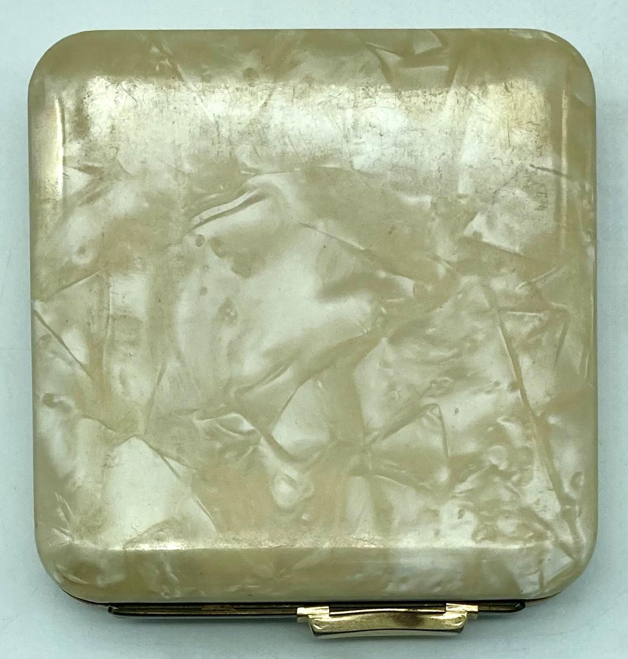 Back of mother of pearl powder compact with enamel badge