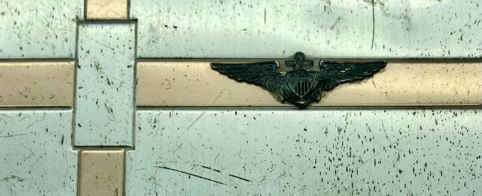 Close-up of US Navy sterling silver powder compact with winged pilot's badge