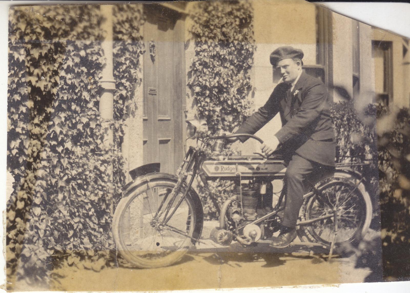 Man seated on a Rudge motorcycle 1914