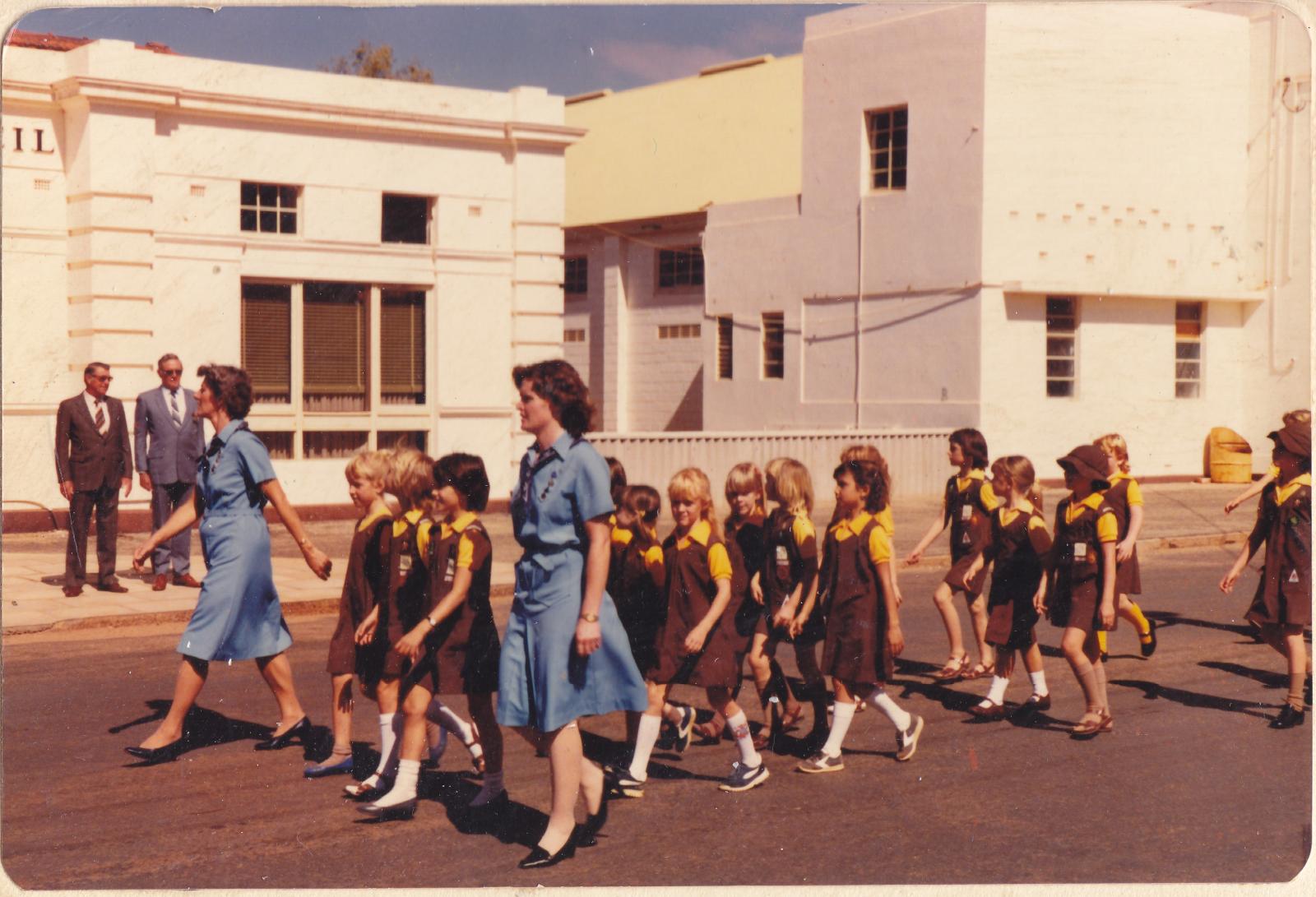 Group of girls in Brownie uniform marching along Prater Street in Morawa 1985