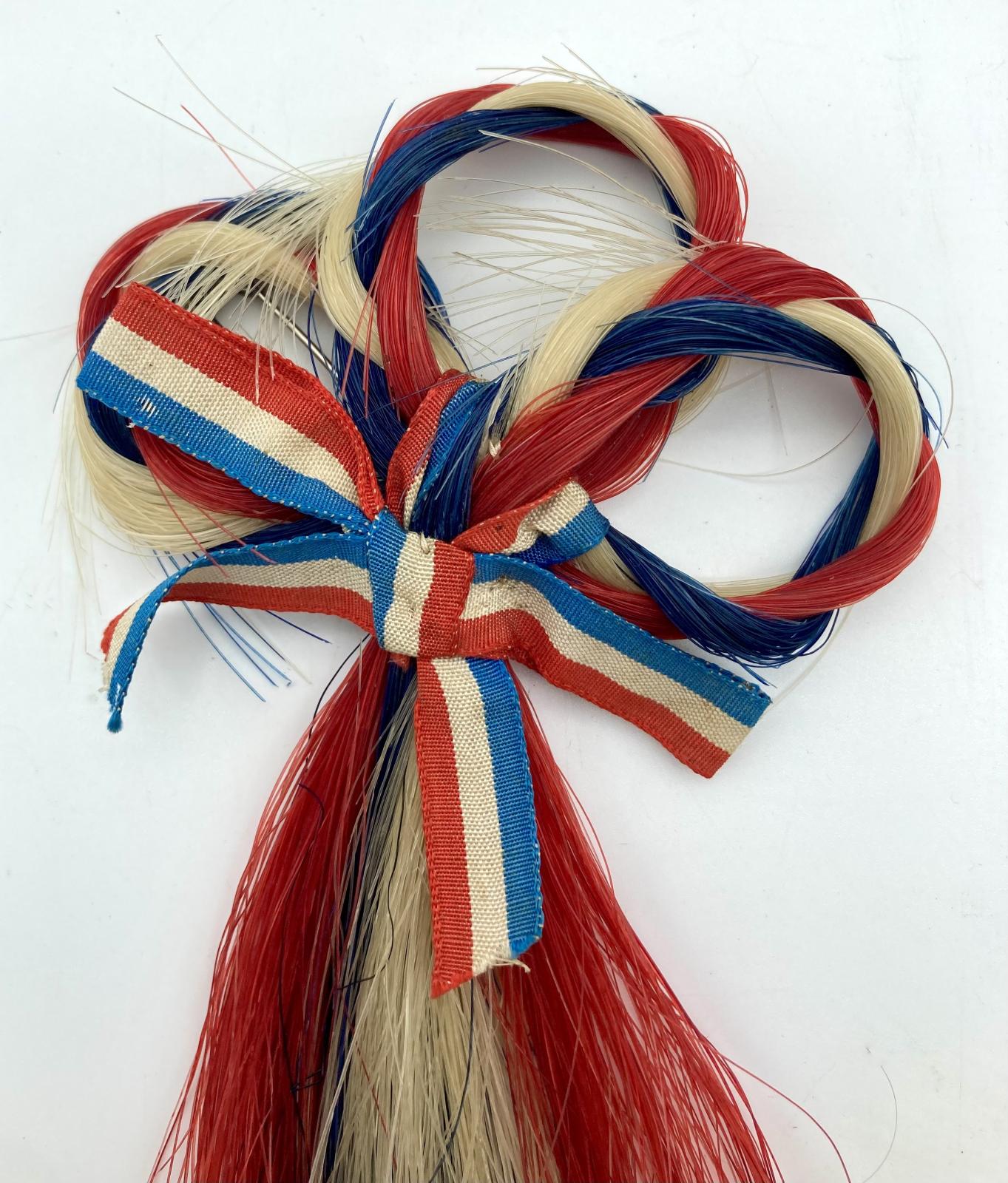 Close-up of WWI patriotic brooch made from horse hair