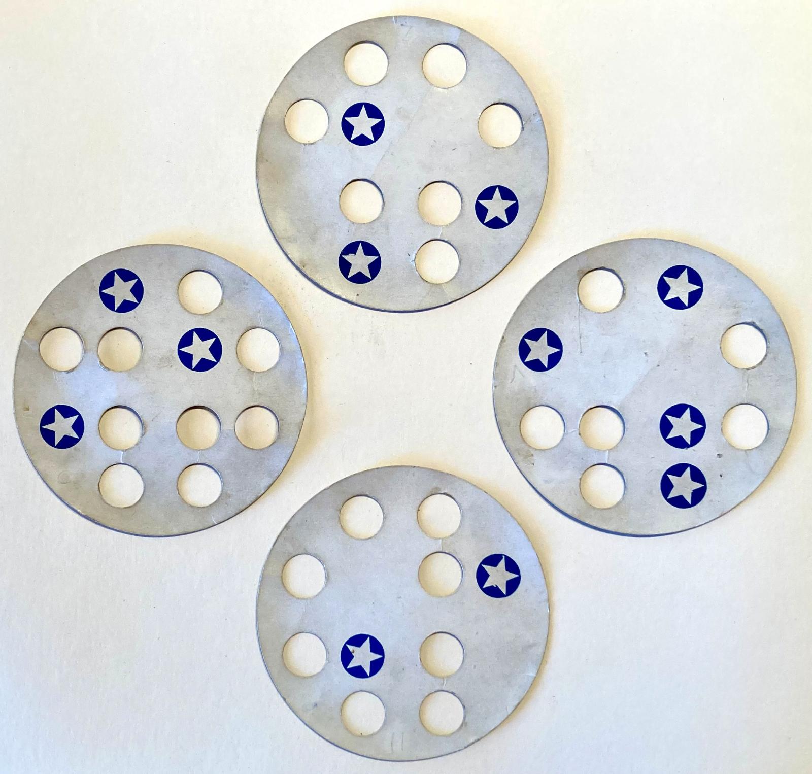 'The Perforated Disc Puzzle' - four discs used to complete puzzle